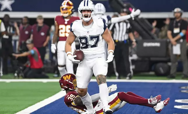 Dallas Cowboys tight end Jake Ferguson (87) celebrates after scoring a touchdown against the Washington Commanders in the second half during an NFL football game in Arlington, Texas, Sunday, Sept. 20, 2026. (AP Photo/Jessica Tobias)