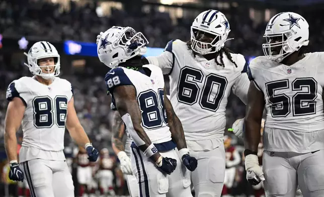 Dallas Cowboys wide receiver Ceedee Lamb (88) celebrates with offensive tackle Tyler Guyton (60) and guard Tyler Booker (52) after scoring a touchdown against the Washington Commanders in the second half during an NFL football game in Arlington, Texas, Sunday, Sept. 20, 2026. (AP Photo/Jessica Tobias)