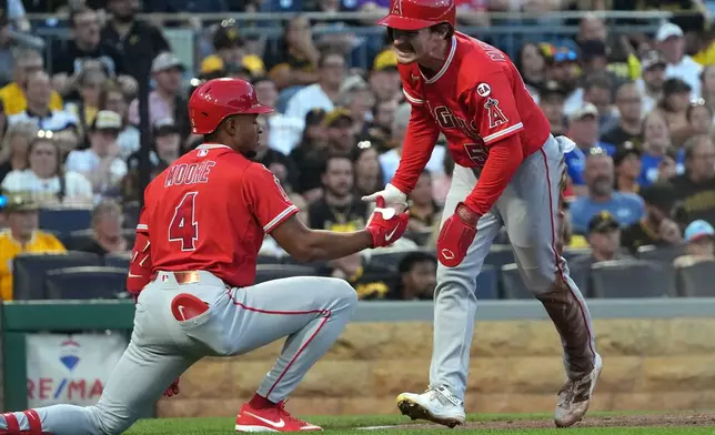 Los Angeles Angels' Wade Meckler, right, celebrates with Christian Moore (4) after scoring on a single hit by Moisés Ballesteros off Pittsburgh Pirates pitcher Braxton Ashcraft during the fourth inning of a baseball game in Pittsburgh, Saturday, Sept. 5, 2026. (AP Photo/Tom E. Puskar)