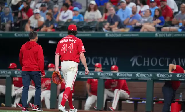 Texas Rangers starting pitcher Cal Quantrill (44) leaves the game with head athletic trainer Matt Lucero during the second inning of a baseball game against the Toronto Blue Jays, Saturday, Sept. 19, 2026, in Arlington, Texas. (AP Photo/Julio Cortez)