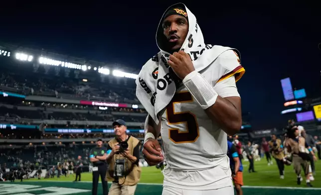 Washington Commanders quarterback Jayden Daniels (5) walks off the field after the team's loss to the Philadelphia Eagles in an NFL football game, Sunday, Sept. 13, 2026, in Philadelphia. (AP Photo/Matt Slocum)