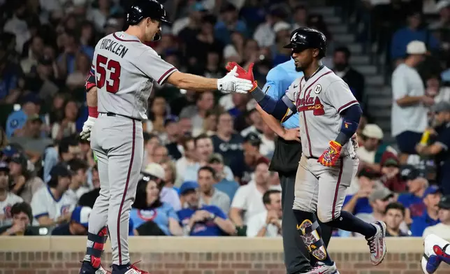 Atlanta Braves' Ozzie Albies, right, celebrates with Brewer Hicklen after hitting a two-run home run during the seventh inning of a baseball game against the Chicago Cubs in Chicago, Tuesday, Sept. 15, 2026. (AP Photo/Nam Y. Huh)