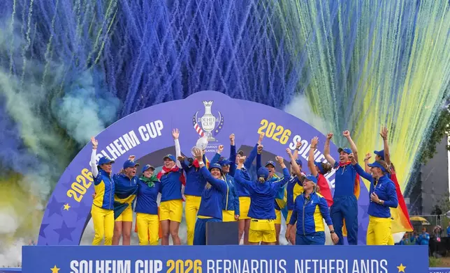 Anna Nordqvist, Europe team captain, holds the trophy aloft after her team won the Solheim Cup in Den Bosch, Netherlands, Sunday, Sept. 13, 2026. (AP Photo/Alastair Grant)