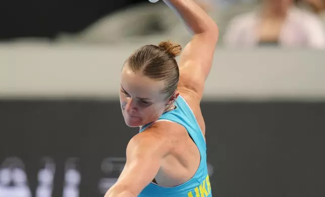 Elina Svitolina of Ukraine raises her racquet to celebrate after defeating Jasmine Paolini of Italy in the Billie Jean King Cup women's singles semifinal between Ukraine and Italy, in Shenzhen, China, Saturday, Sept. 26, 2026. (AP Photo/Andy Wong)