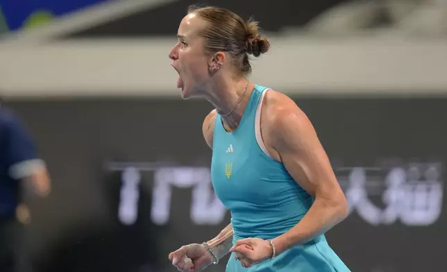 Elina Svitolina of Ukraine celebrates winning her match against Jasmine Paolini of Italy in the Billie Jean King Cup women's singles semifinal between Ukraine and Italy, in Shenzhen, China, Saturday, Sept. 26, 2026. (AP Photo/Andy Wong)