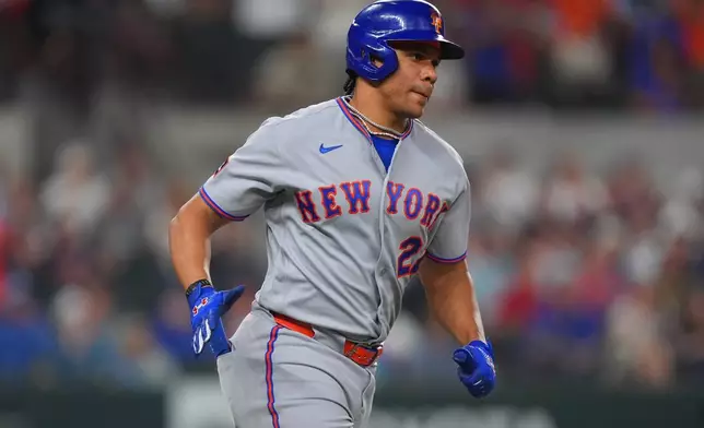 New York Mets' Juan Soto runs the bases after hitting an two homer during the third inning of a baseball game against the Texas Rangers, Wednesday, Sept. 23, 2026, in Arlington, Texas. (AP Photo/LM Otero)
