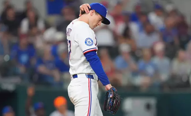 Texas Rangers pitcher Jacob Latz looks on after giving up a home run to New York Mets' Marcus Semien during the eighth inning of a baseball game, Wednesday, Sept. 23, 2026, in Arlington, Texas. (AP Photo/LM Otero)