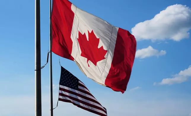 The national flags of Canada, front, and the United States fly outside the Galleria Mall in Buffalo, New York, Wednesday, Aug. 26, 2026. (AP Photo/Gene J. Puskar)