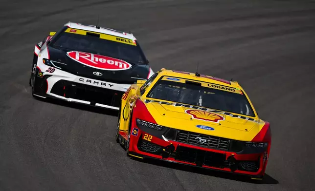 Christopher Bell (20) and Joey Logano (22) compete during a NASCAR Cup Series auto race Sunday, Sept. 13, 2026, in Madison, Ill. (AP Photo/Connor Hamilton)