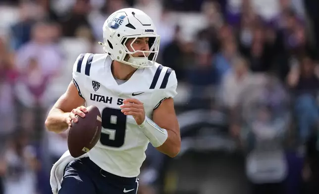 Utah State quarterback Grady Brosterhous runs against Washington during the first half of an NCAA college football game Saturday, Sept. 12, 2026, in Seattle. (AP Photo/Lindsey Wasson)