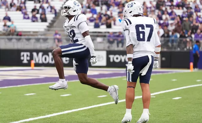 Utah State safety Chika Ebunoha (12) reacts after tackling Washington's Rahshawn Clark for a short gain on a punt return during the second half of an NCAA college football game Saturday, Sept. 12, 2026, in Seattle. (AP Photo/Lindsey Wasson)