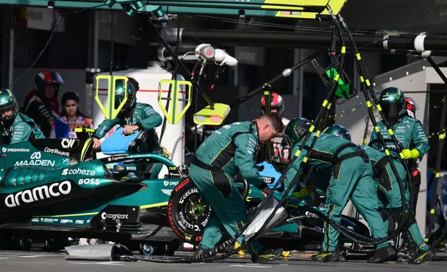 Mechanics push car of Aston Martin driver Fernando Alonso of Spain during the Azerbaijan F1 Grand Prix auto race, in Baku, Azerbaijan, Saturday, Sept. 26, 2026. (Andrej Isakovic/Pool via AP)