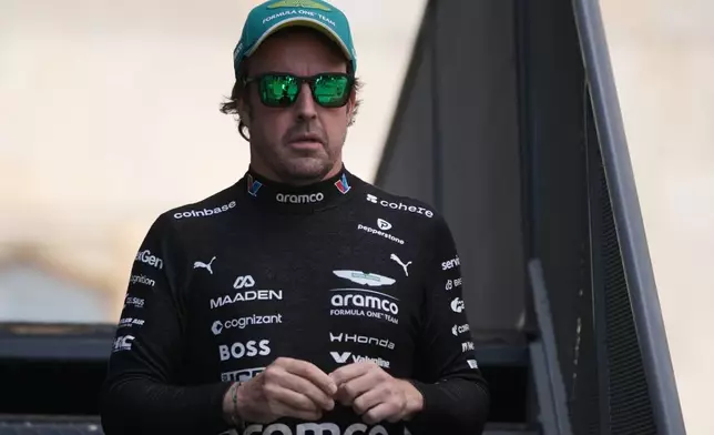 Aston Martin driver Fernando Alonso of Spain walks through the paddock prior to the qualifying session for the Azerbaijan F1 Grand Prix, in Baku, Azerbaijan, Friday, Sept. 25, 2026. (AP Photo/Pavel Bednyakov)
