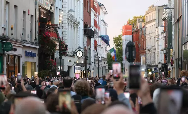 U2 perform an impromptu concert from a balcony in central Dublin, Ireland , Friday, Sept. 25, 2026. (AP Photo/Peter Morrison)