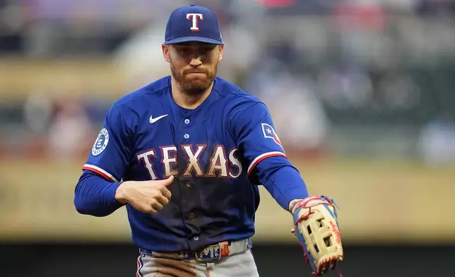 Texas Rangers' Brandon Nimmo walks back to the dugout after the bottom of the second inning of a baseball game against the Minnesota Twins, Saturday, Sept. 26, 2026, in Minneapolis. (AP Photo/Abbie Parr)