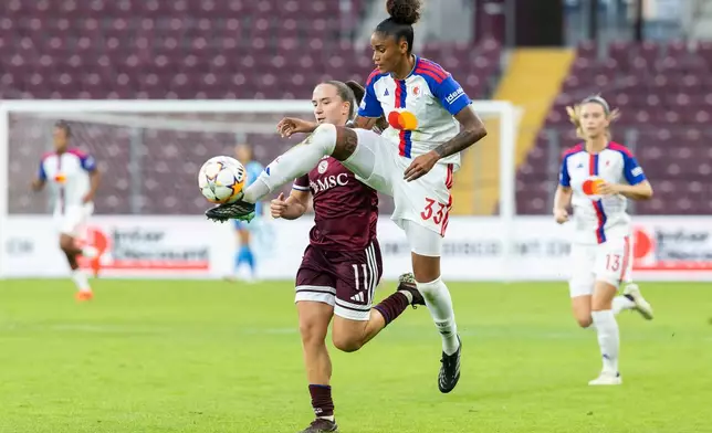 OL Lyonnes' Tarciane, right, plays the ball in front of Servette FC Chenois's Magdalena Sobal during a UEFA Women's Champions League soccer match in Geneva, Switzerland, Wednesday, Sept. 23, 2026. (Cyril Zingaro/Keystone via AP)