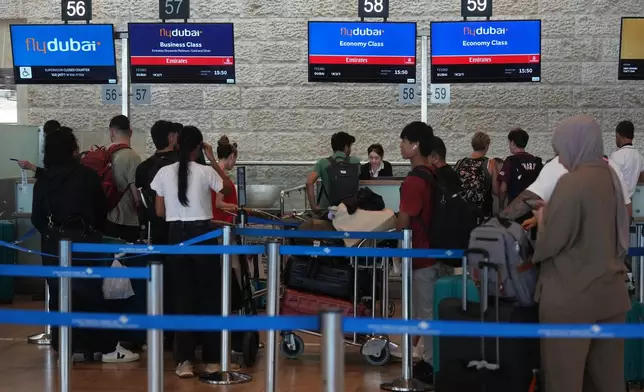 Passengers wait in line to check in their luggage with FlyDubai at Ben Gurion International Airport, near Tel Aviv, Israel, Wednesday, Sept. 30, 2026. (AP Photo/Ariel Schalit)