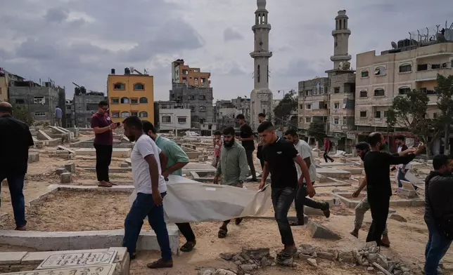 Mourners carry the remains of Palestinians killed in Israeli strikes during the war with Hamas after they were recovered from the rubble, during their funeral in Nuseirat, Gaza Strip, Tuesday, Sept. 29, 2026. (AP Photo/Jehad Alshrafi)