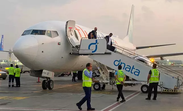 FILE - Israeli tourists leave a FlyDubai plane which departed from Ben-Gurion International Airport in Tel Aviv and landed in Dubai, United Arab Emirates, Nov. 8, 2020.(AP Photo/Malak Harb, File)