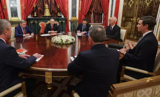 President Vladimir Putin, background center left, speaks to U.S. President Donald Trump's envoys Steve Witkoff, center foreground, back to a camera, and Jared Kushner, right, as Kremlin foreign policy adviser Yuri Ushakov, second left, and Presidential Envoy Kirill Dmitriev attend the talks at the Senate Palace of the Kremlin in Moscow, on Saturday, Sept. 5, 2026. (Gavriil Grigorov/Sputnik/Kremlin Pool Photo via AP)