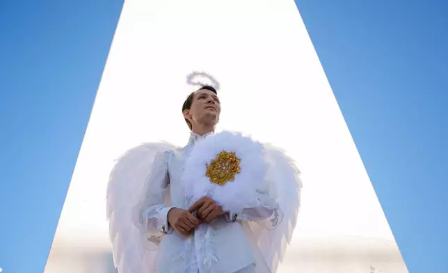 A man dressed as an angel attends an event dubbed the Little Angels' Parade, a Christian-themed street performance featuring dozens of children wearing angel costumes, in Bucharest, Romania, Saturday, Sept. 5, 2026. (AP Photo/ Vadim Ghirda)
