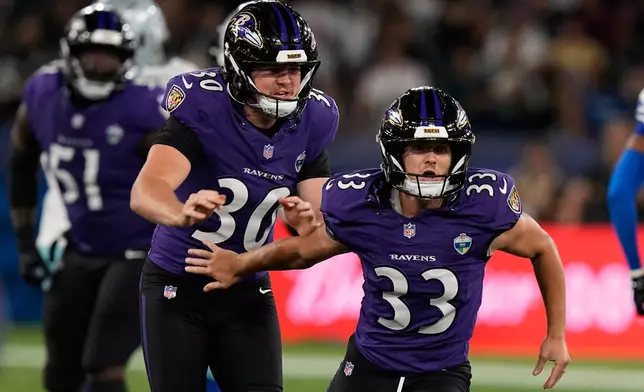 Baltimore Ravens place kicker Tyler Loop (33) celebrates with punter Ryan Eckley (30) during the second half of an NFL football game in Rio de Janeiro, Sunday, Sept. 27, 2026. (AP Photo/Fernando Llano)
