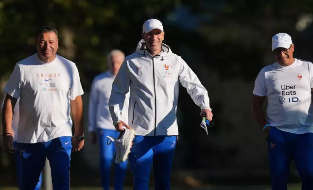 France national soccer team coach Zinedine Zidane, center, arrives for a training session in Clairefontaine-en-Yvelines west of Paris, Tuesday, Sept. 22, 2026, three days ahead of France's UEFA Nations League soccer match against Turkey. (AP Photo/Thibault Camus)