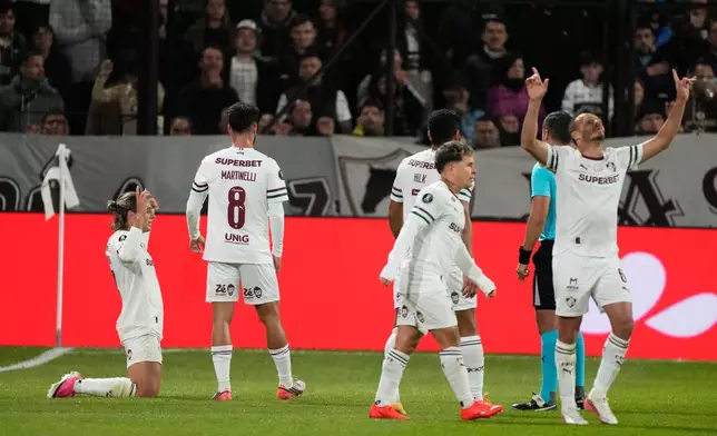 Agustin Canobbio of Brazil's Fluminense, left, celebrates with teammates after scoring his side's opening goal against Argentina's Platense during a Copa Libertadores quarter final second leg soccer match in Buenos Aires, Argentina, Tuesday, Sept. 15, 2026. (AP Photo/Gustavo Garello)