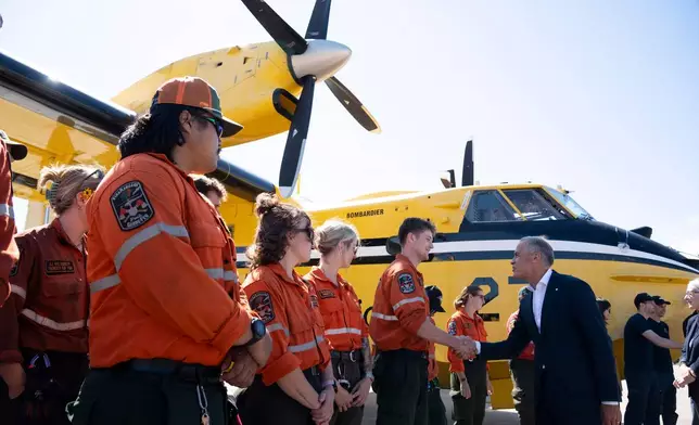 Ontario Wildland Firefighters greet Prime Minister Mark Carney at the Thunder Bay Fire Management Centre in Thunder Bay, Ontario, Canada, on Thursday, Sept. 3, 2026. (David Jackson/The Canadian Press via AP)
