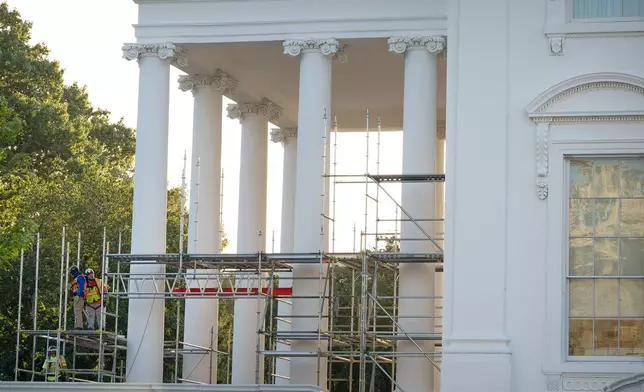 Workers remove scaffolding from columns at the North Portico of the White House, Tuesday, Sept. 8, 2026, in Washington. (AP Photo/Mark Schiefelbein)