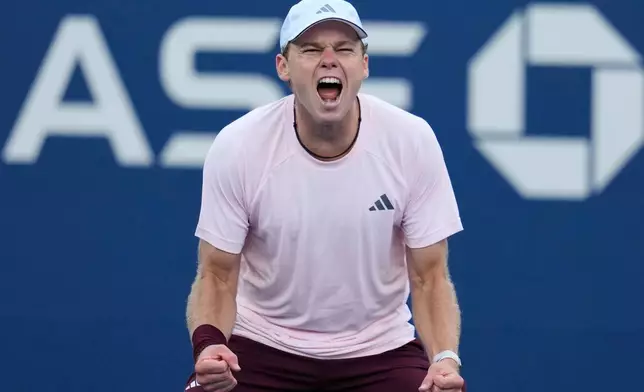 Alex Michelsen, of the United States, reacts after he won his match against Tomas Martin Etcheverry, of Argentina, during the fourth round of the U.S. Open tennis championships Sunday, Sept. 6, 2026, in New York. (AP Photo/Seth Wenig)