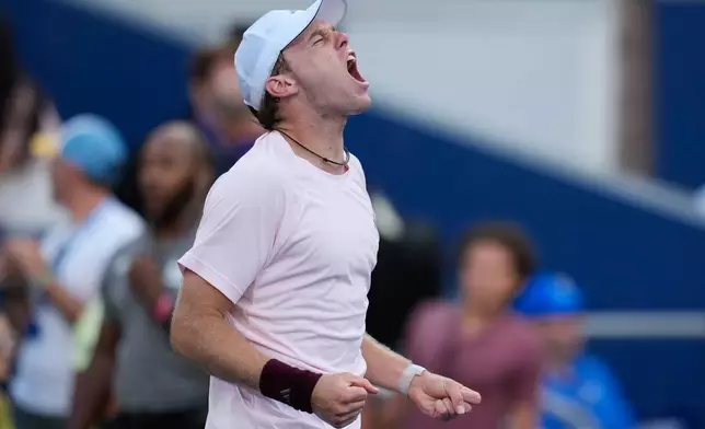 Alex Michelsen, of the United States, reacts after he won his match against Tomas Martin Etcheverry, of Argentina, during the fourth round of the U.S. Open tennis championships Sunday, Sept. 6, 2026, in New York. (AP Photo/Seth Wenig)