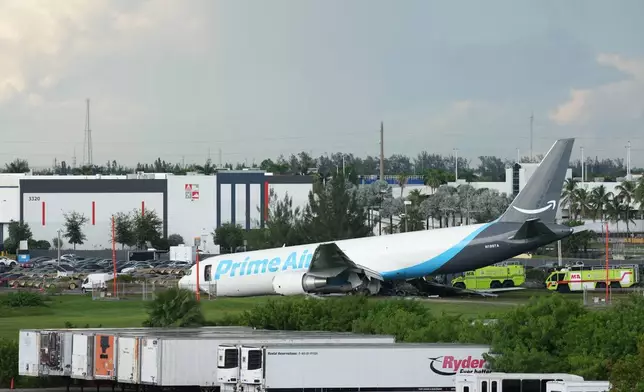 An Amazon cargo plane sits at the Miami International Airport (MIA) after it overshot the runway, Sunday, Sept. 6, 2026. (AP Photo/Lynne Sladky)