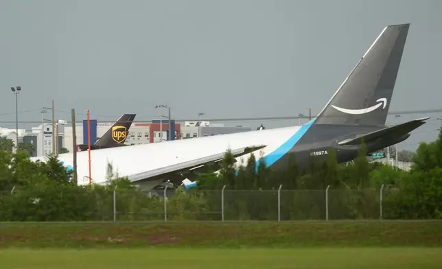 An Amazon cargo plane sits at the Miami International Airport (MIA) after it overshot the runway, Sunday, Sept. 6, 2026. (AP Photo/Lynne Sladky)