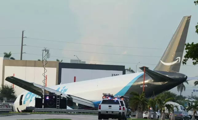 An Amazon cargo plane sits at the Miami International Airport (MIA) after it overshot the runway, Sunday, Sept. 6, 2026. (AP Photo/Lynne Sladky)