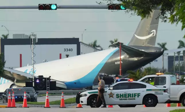 An Amazon cargo plane sits at the Miami International Airport (MIA) after it overshot the runway, Sunday, Sept. 6, 2026. (AP Photo/Lynne Sladky)