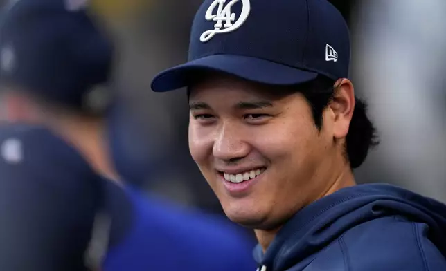 Los Angeles Dodgers' Shohei Ohtani smiles in the dugout during the first inning of a baseball game against the Washington Nationals, Saturday, Sept. 5, 2026, in Los Angeles. (AP Photo/Mark J. Terrill)