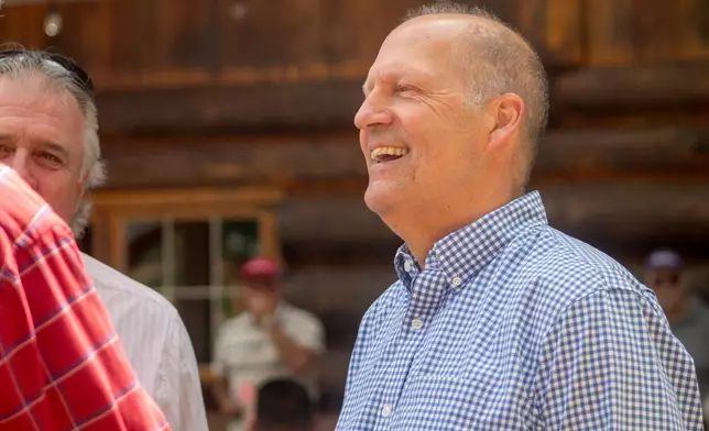 Former Sen. John E. Sununu, who is running for his old seat nearly 18 years after being ousted, mingles with voters at the Coos County Republican Committee BBQ in Berlin, N.H., Saturday, Aug. 22, 2026. (AP Photo/Holly Ramer)