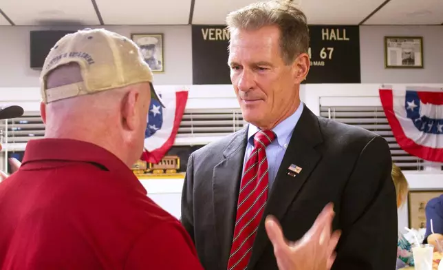 Former U.S. Sen. Scott Brown listens to a voter in Londonderry, New Hampshire, on Thursday, Aug. 27, 2026, as he campaigns for the GOP nomination for the state’s open Senate seat. (AP Photo/Holly Ramer)