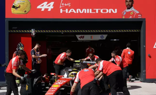 Ferrari driver Lewis Hamilton of Britain gets pushed back into his garage during the qualifying session for the Spanish Formula One Grand Prix in Madrid, Saturday, Sept. 12, 2026. (Violeta Santos Moura/Pool Photo via AP)