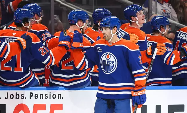 Edmonton Oilers' Evan Bouchard (2) celebrates a goal against the Vancouver Canucks during the first period of an NHL hockey game in Edmonton, Tuesday, Sept. 29, 2026. (Codie McLachlan/The Canadian Press via AP)