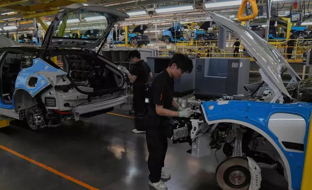 FILE - Workers assemble the Zeekr 001 EV models at the Chinese automaker Zeekr assembly plant in Ningbo, east China's Zhejiang Province, April 17, 2025. (AP Photo/Andy Wong, File)