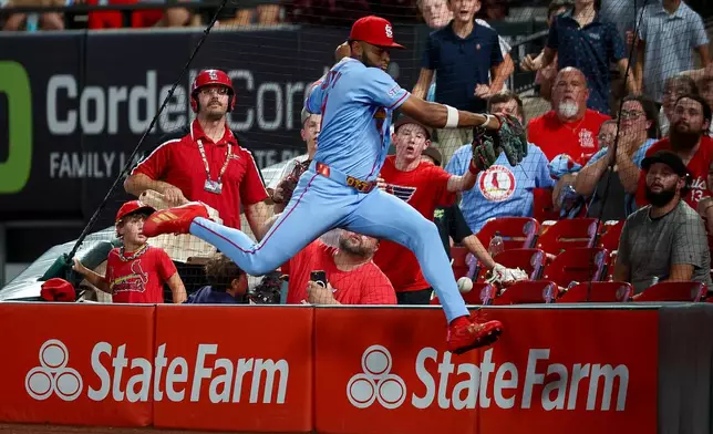 St. Louis Cardinals' Victor Scott II is unable to catch a foul ball hit by Washington Nationals' Harry Ford during the eighth inning of a baseball game Friday, Sept. 18, 2026, in St. Louis. (AP Photo/Scott Kane)