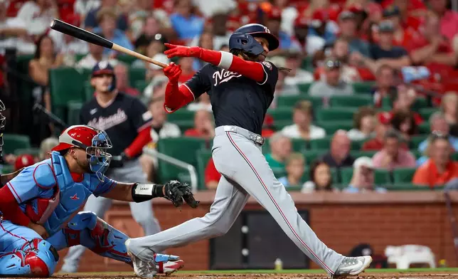 Washington Nationals' CJ Abrams, right, follows through on an RBI single during the first inning of a baseball game against the St. Louis Cardinals, Friday, Sept. 18, 2026, in St. Louis. (AP Photo/Scott Kane)