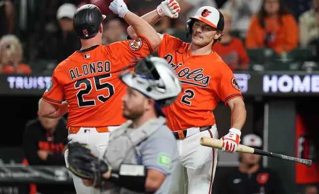 Baltimore Orioles' Pete Alonso (25) celebrates with Gunnar Henderson (2) after hitting a home run during the first inning of a baseball game against the Toronto Blue Jays, Monday, Sept. 21, 2026, in Baltimore. (AP Photo/Stephanie Scarbrough)