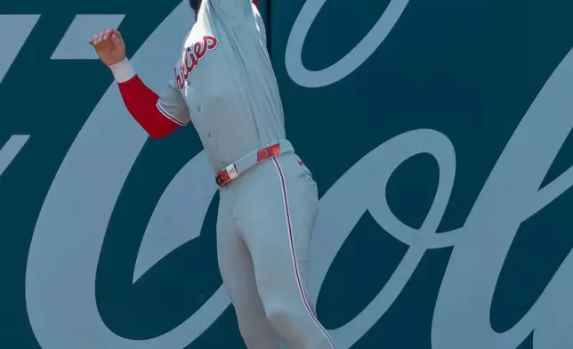 Philadelphia Phillies right fielder Bryce Harper catches a sacrifice fly hit by Atlanta Braves' Drake Baldwin during the first inning of a baseball game, Sunday, Sept. 13, 2026, in Atlanta. (AP Photo/Erik S. Lesser)