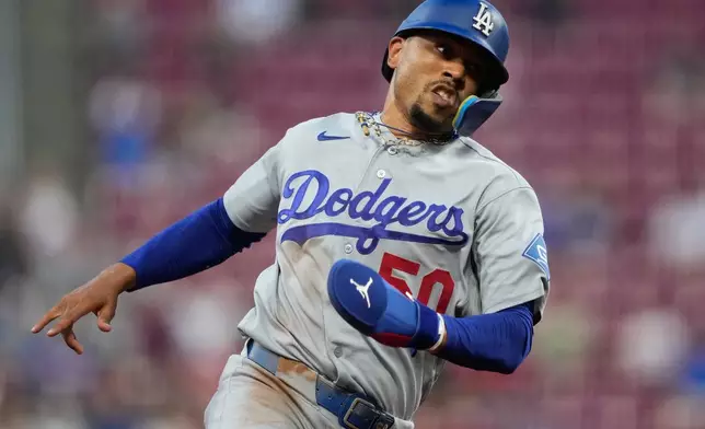 Los Angeles Dodgers' Mookie Betts rounds third base on his way to score on a double hit by Will Smith during the third inning of a baseball game against the Cincinnati Reds, Wednesday, Sept. 16, 2026, in Cincinnati. (AP Photo/Carolyn Kaster)