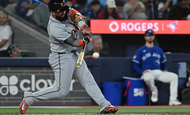 Detroit Tigers second baseman Gleyber Torres (25) hits a single against the Toronto Blue Jays during the seventh inning of a baseball game in Toronto on Monday, Sept. 14, 2026. (Jon Blacker/The Canadian Press via AP)