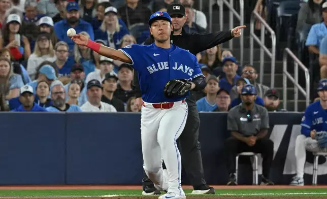 Toronto Blue Jays infielder Kazuma Okamoto (7) throws to first base to put out Detroit Tigers' Dillon Dingler during the fifth inning of a baseball game in Toronto on Monday, Sept. 14, 2026. (Jon Blacker/The Canadian Press via AP)