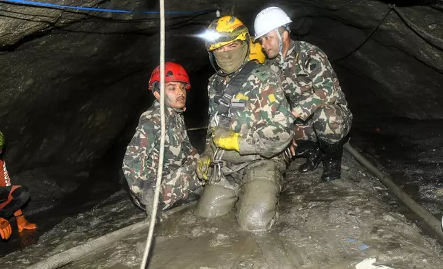 In this handout photograph provided by the Nepal Army, Nepalese soldiers undertake a search and rescue operation at the Chilime hydropower project following earlier flash floods in Nepal's Rasuwa district, Wednesday, Sept. 16, 2026. (Nepal Army via AP)